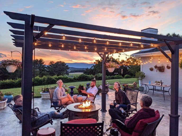 Family enjoying their backyard pergola person sky deck grass