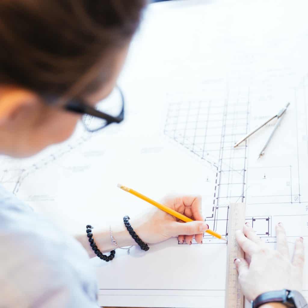 Woman engineer working on blueprint person