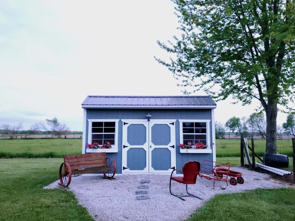 shed doors windows in grass with outdoor decor