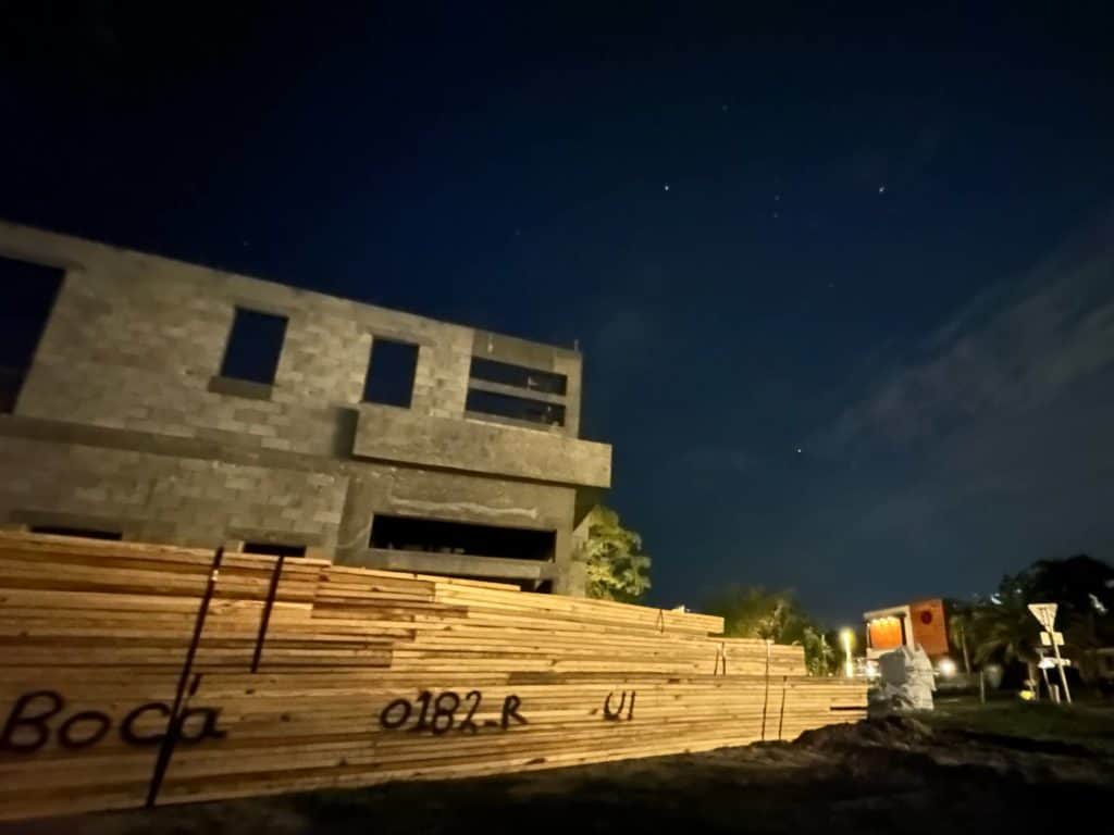 night shot of wood trusses delivered to jobsite before installation